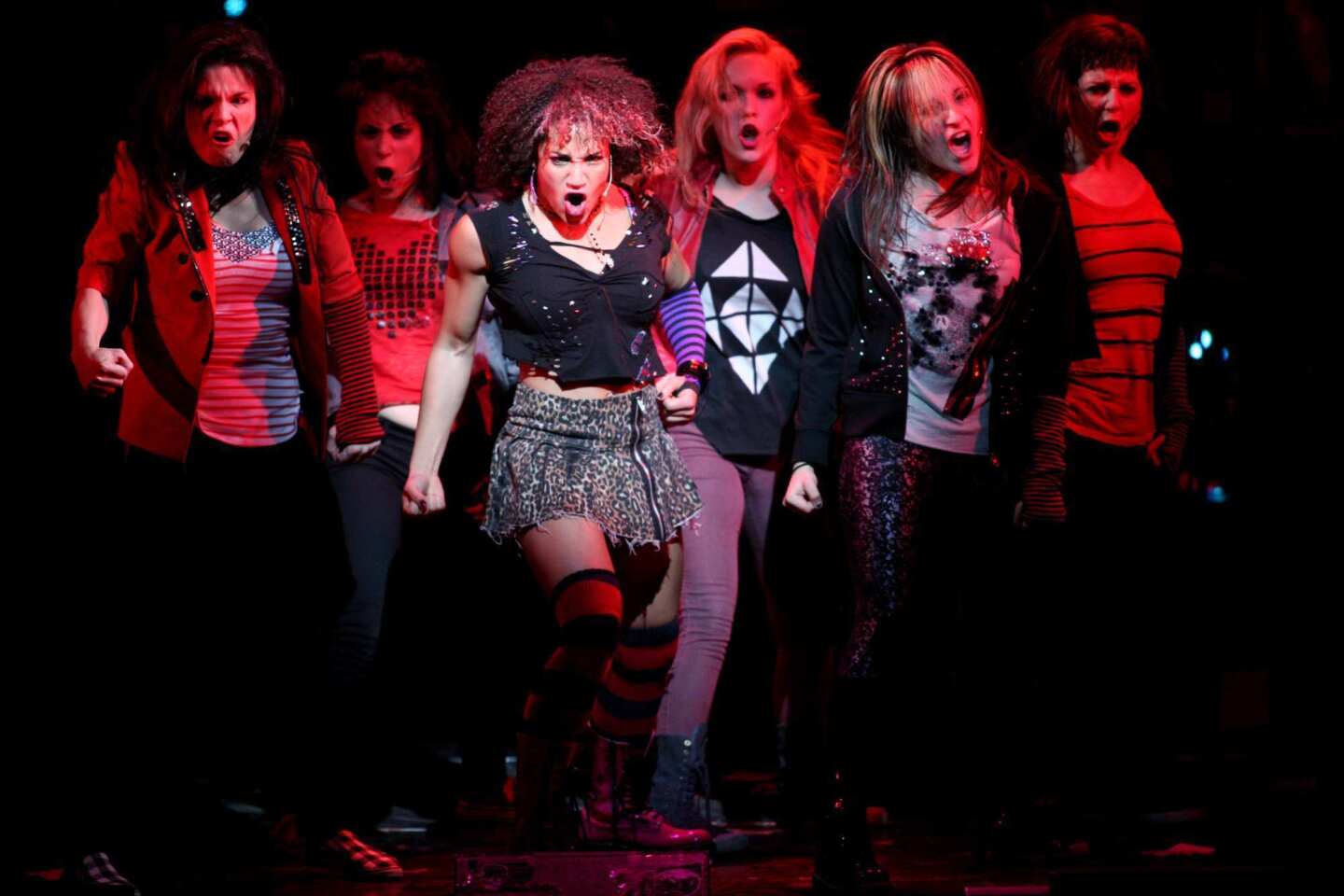 Drugs pull Jimmy in one direction; the strong, fierce, powerfully attractive Whatsername, played by Gabrielle McClinton, third from left, tries to pull him in another. "American Idiot" is visiting the Ahmanson Theatre.