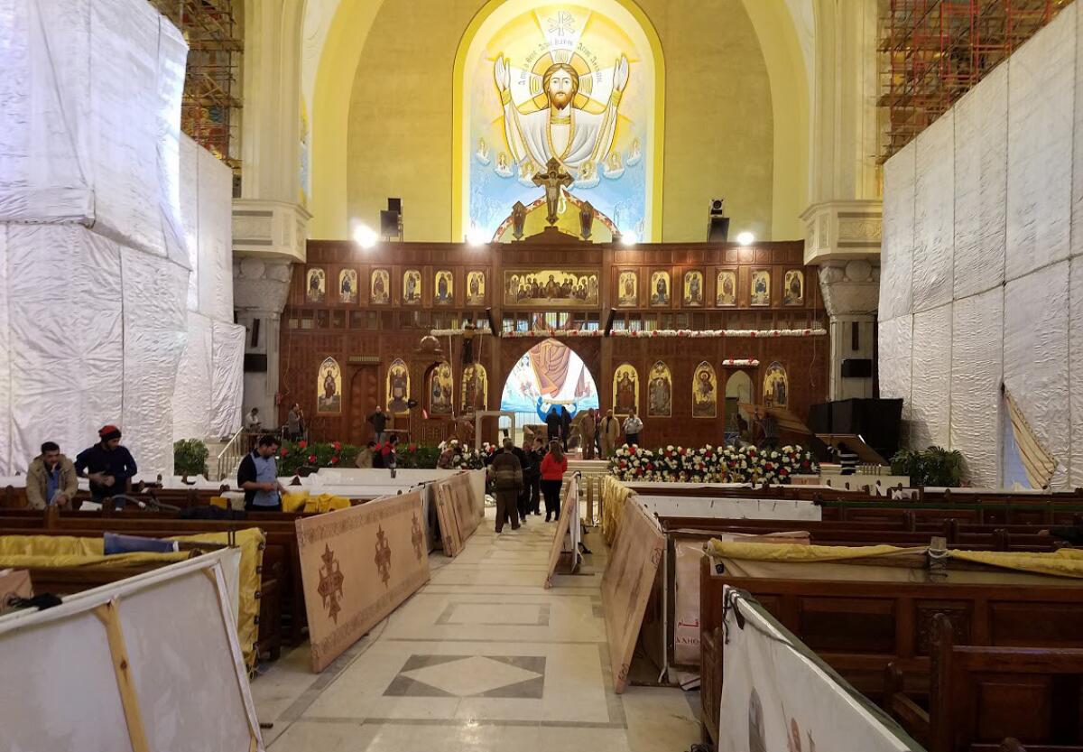 Workers prepare for Christmas Eve Mass to be held Friday night at St. Mark’s Coptic Orthodox Cathedral in Cairo.
