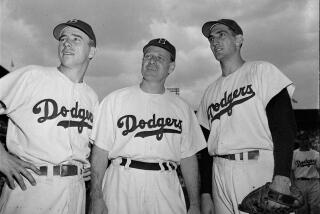 FILE - In this July 8, 1948 file photo, Brooklyn Dodgers manager Leo Durocher, center, poses with shortstop Pee Wee Reese, left, and pitcher Ralph Branca, right, at Ebbets Field in New York. Branca, the Brooklyn Dodgers pitcher who gave up the home run dubbed the "Shot Heard 'Round the World," has died at the age of 90. His son-in-law Bobby Valentine, a former major league manager, says Branca died Wednesday, Nov. 23, 2016, at a nursing home in Rye, New York. (AP Photo/Harry Harris, File)
