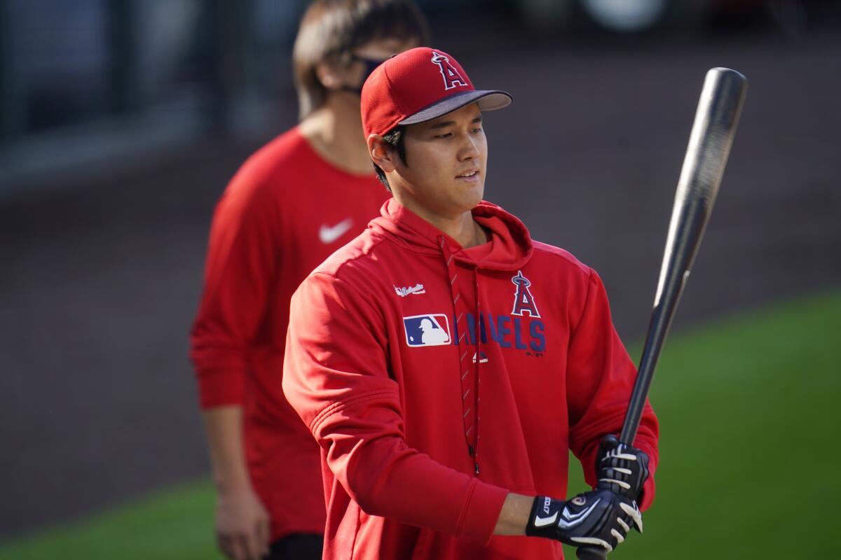 Shohei Ohtani warms up before a spring training game.