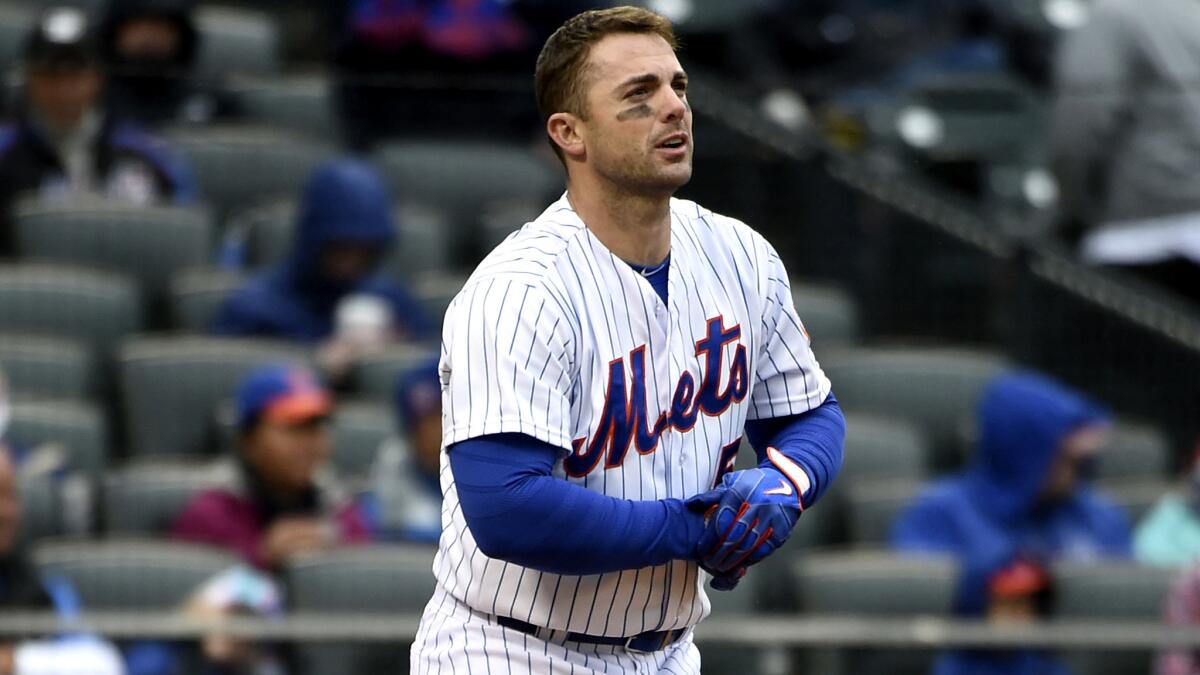 Mets third baseman David Wright takes off his gear after striking out against the Nationals in the seventh inning of the first game of a doubleheader Saturday.