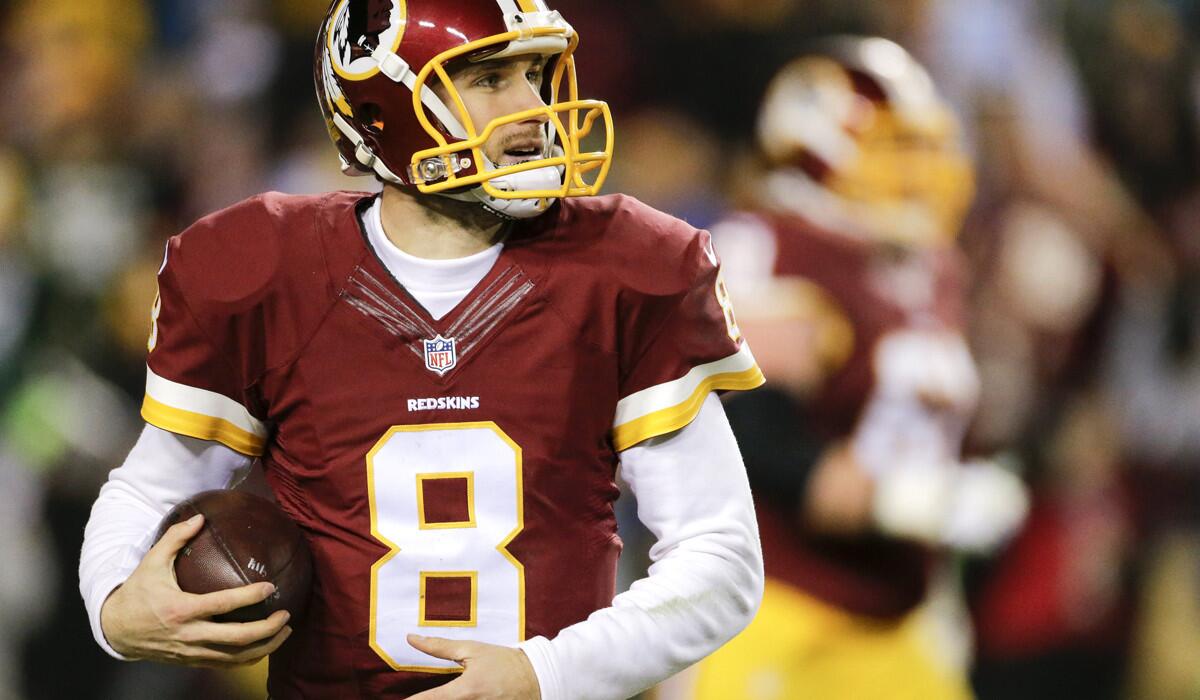 Washington Redskins quarterback Kirk Cousins looks up at the scoreboard after scoring a touchdown during the second half of an NFL wild card playoff football game against the Green Bay Packers Jan. 10.