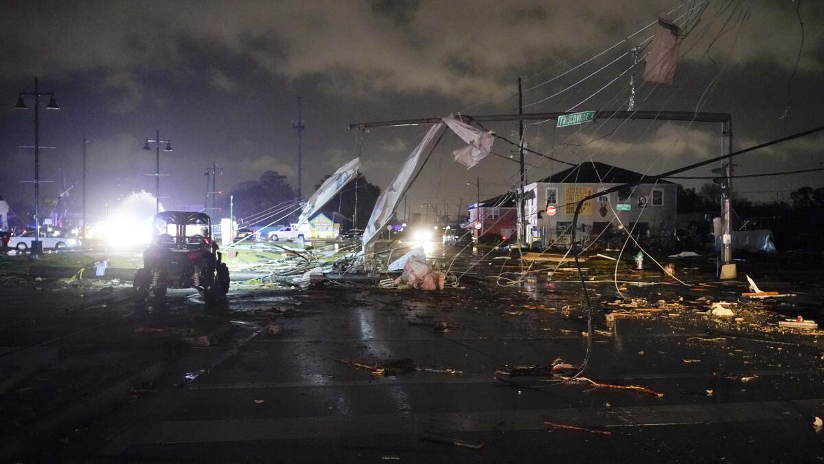 Debris is strewn across an intersection at night. 