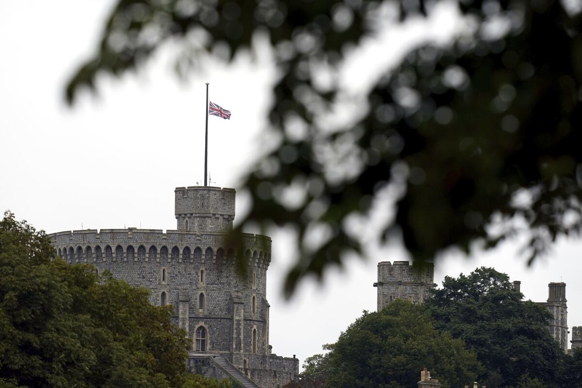 The British flag flies at half mast at Windsor Castle, Berkshire, following Thursday's death of Queen Elizabeth II, Friday Sept. 9, 2022. Queen Elizabeth II, Britain's longest-reigning monarch and a rock of stability across much of a turbulent century, died Thursday at the age of 96 after 70 years on the throne. (John Walton/PA Wire/PA via AP)