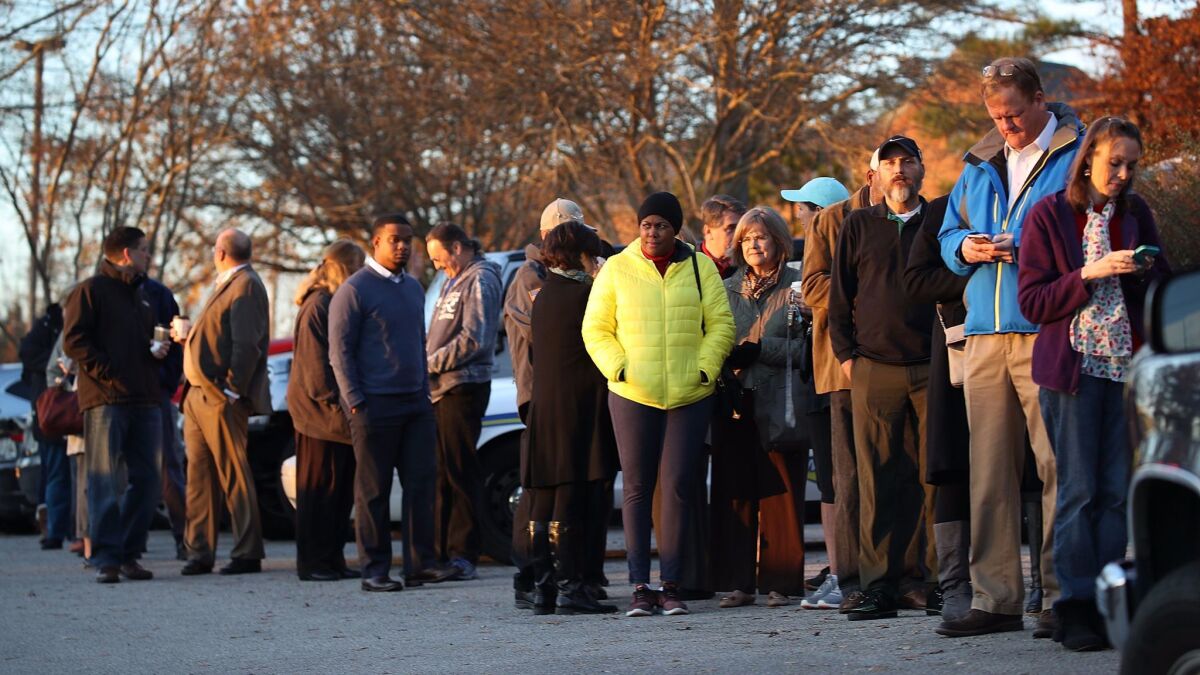 Voters wait in line to cast their ballots at a polling station in Birmingham, Ala., on Tuesday.