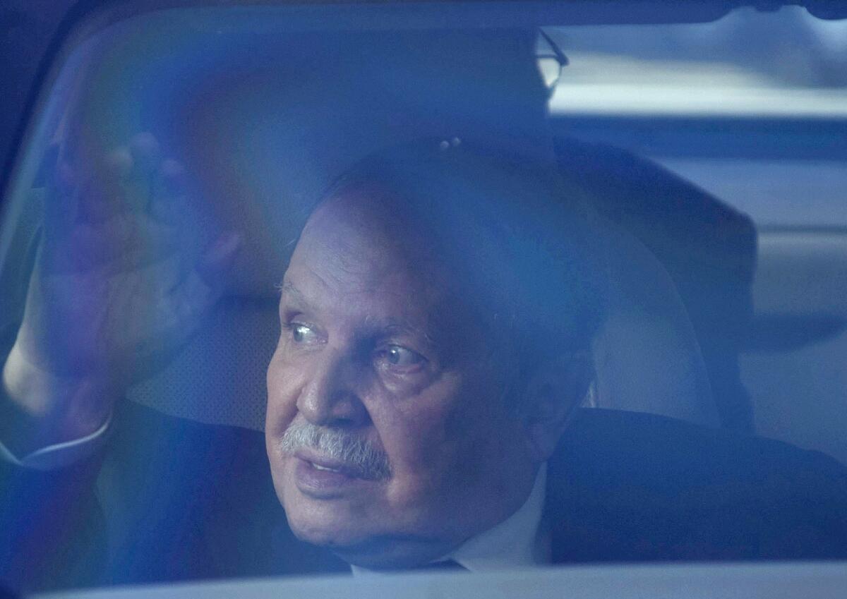 Algerian President Abdelaziz Bouteflika waves from inside a vehicle on March 3, 2014, in Algiers.