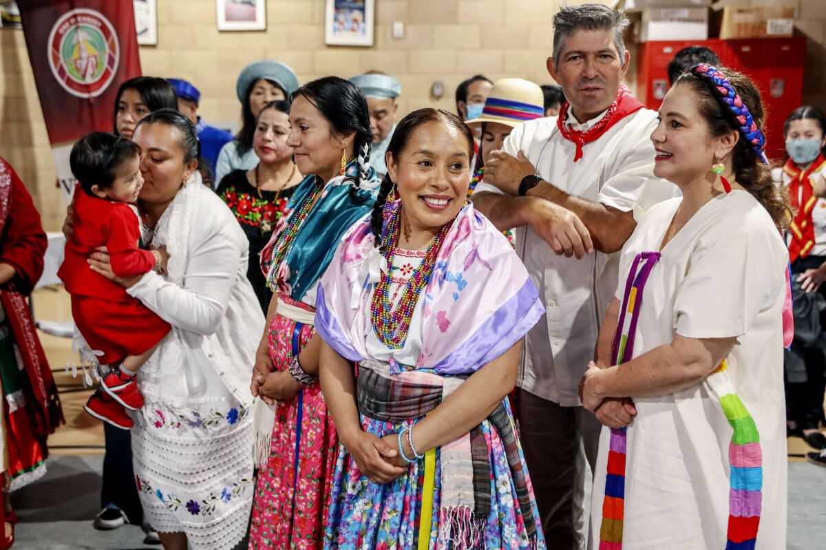 Church-goers from different nations wait backstage before marching in a procession at a Pentecost Mass.