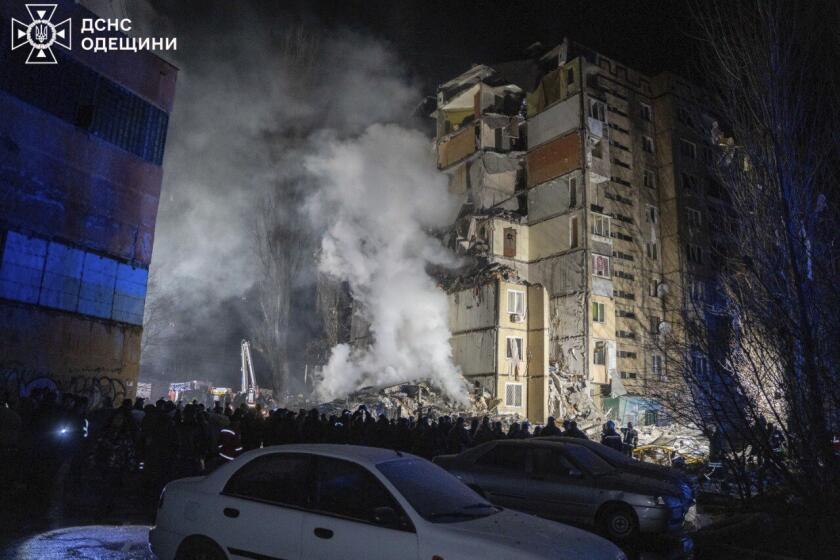 In this photo provided by the Ukrainian Emergency Service, emergency workers clear the rubble on the site of a destroyed multi-store building after a Russian attack on residential neighbourhood in Odesa, Ukraine, Saturday, March 2, 2024. (Ukrainian Emergency Service Office via AP)