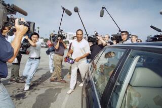 O.J. Simpson is surrounded by media as he departs Santa Monica Superior Court in Santa Monica, California on Thursday, May 15, 1997. (AP Photo/Nick Ut)