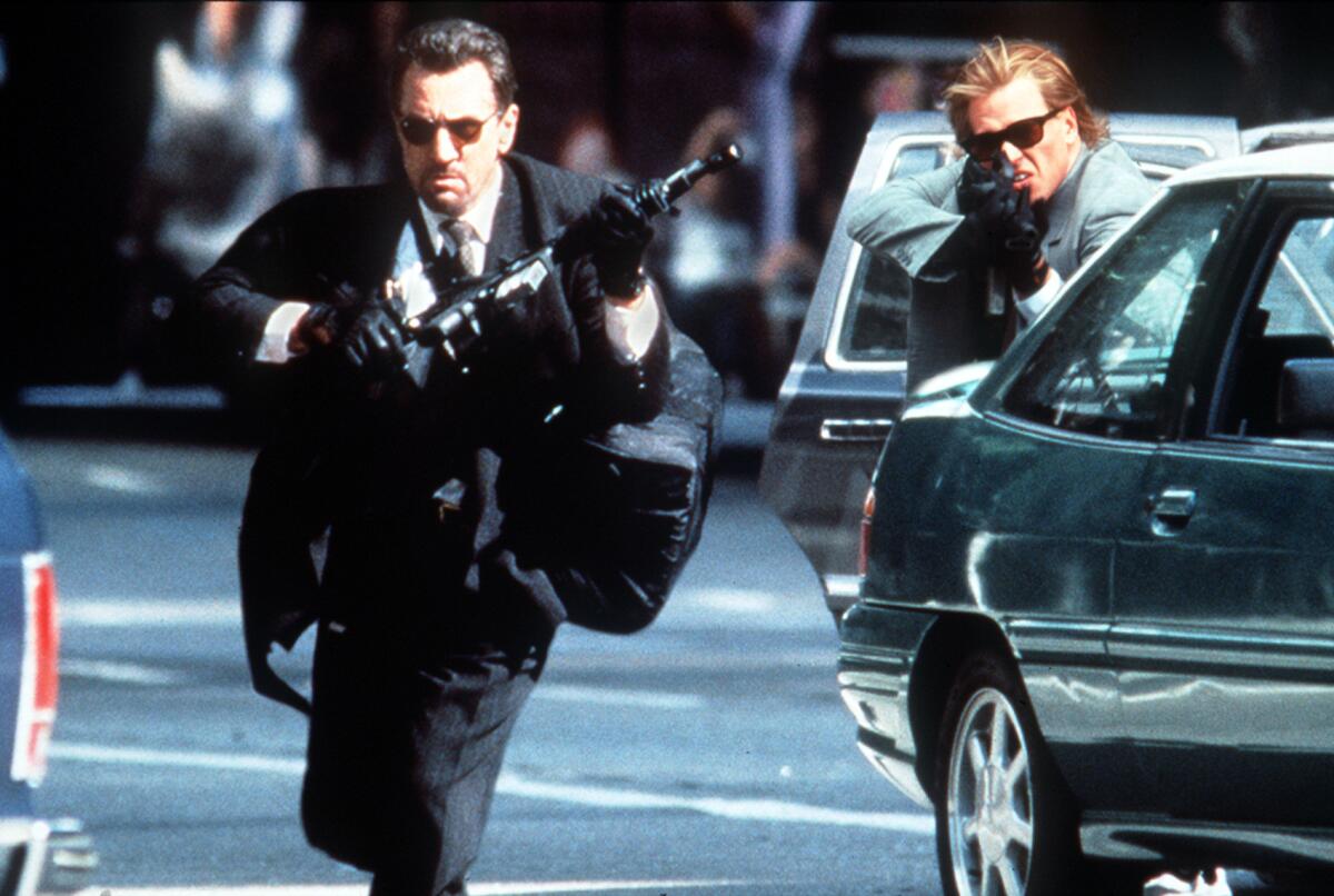 Robert De Niro carries a big gun and Val Kilmer points one.