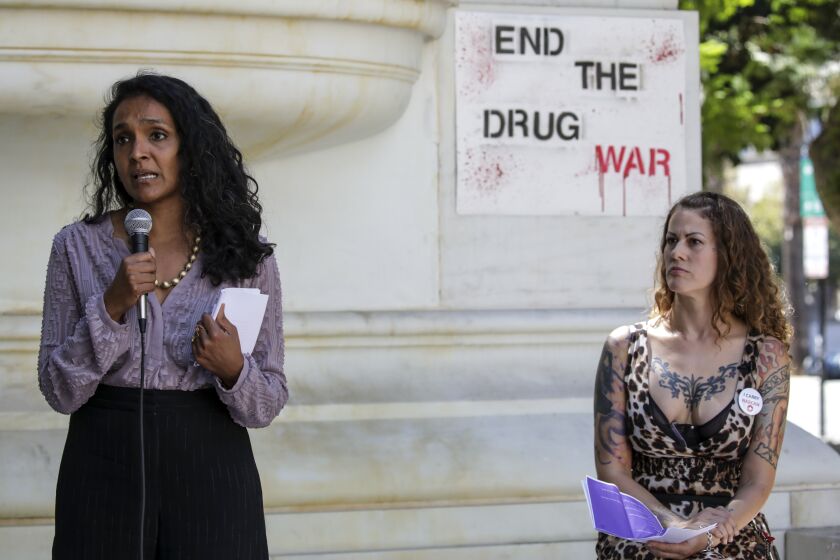 Los Angeles, CA - August 31: City council member Nithya Raman, left, flanked by Soma Snakeoil, founder of Sidewalk Project, speaks at a rally held to mark International Overdose Awareness Day outside City Hall on Wednesday, Aug. 31, 2022 in Los Angeles, CA. (Irfan Khan / Los Angeles Times)