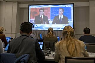 Florida Governor and Republican presidential hopeful Ron DeSantis (L) and California Governor Gavin Newsom (R) appear on screen from the press room during a debate held by Fox News, in Alpharetta, Georgia, on November 30, 2023. (Photo by Christian MONTERROSA / AFP) (Photo by CHRISTIAN MONTERROSA/AFP via Getty Images)