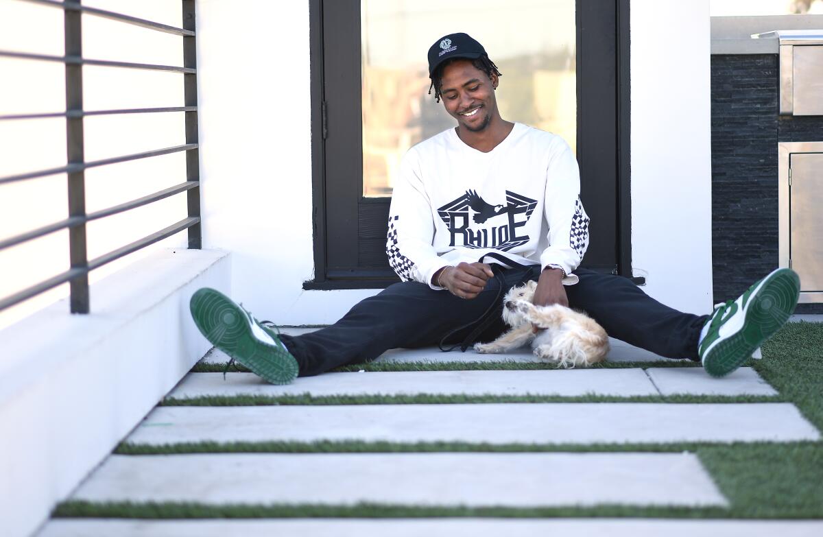 Former Clipper forward Maurice Harkless sits home with his dog, Biggie, in Venice.