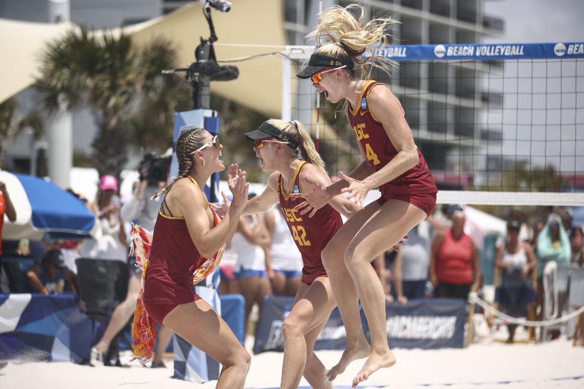 USC's Olivia Bakos (5), Nicole Nourse (42) and Audrey Nourse (24) celebrate after defeating the UCLA.