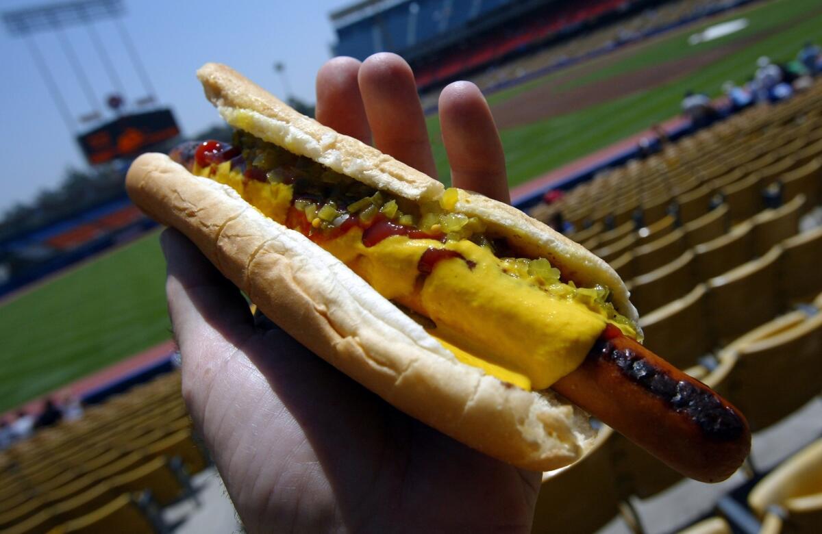 A Dodger Dog slathered in mustard, ketchup and relish at Dodger Stadium.