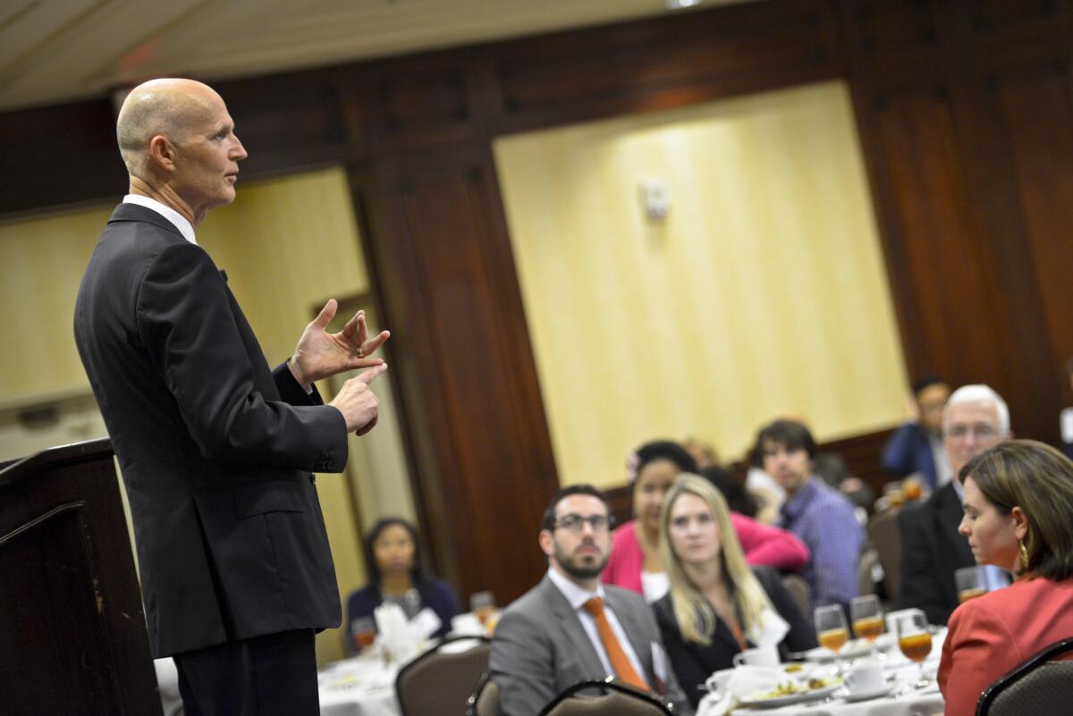 Florida Gov. Rick Scott speaks to an audience of business representatives in Woodland Hills in April 2015 during his last visit to try to lure California employers to his state. This week, he's back.