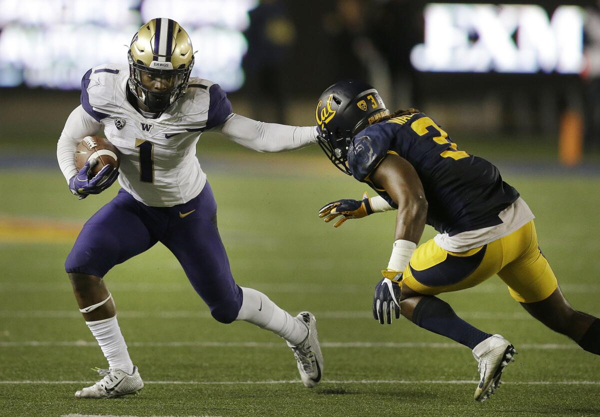 Washington receiver John Ross (1) tries to avoid a tackle attempt by California's Cameron Walker during the second half on Nov. 5.