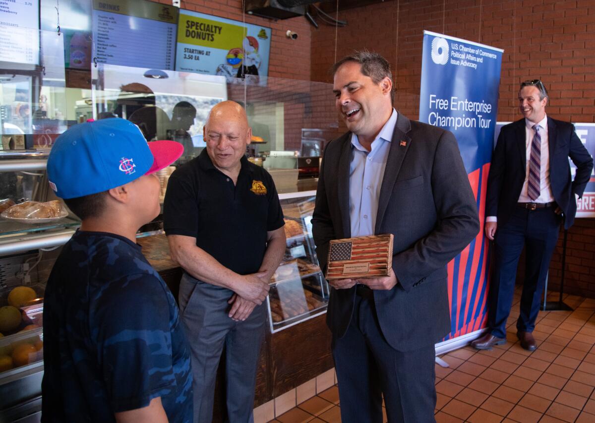 Congressman Mike Garcia talks to customers at a bakery during his 2022 campaign. 