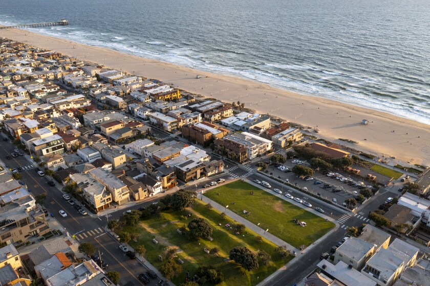 An aerial view of Bruce's Beach park and the lifeguard building overlooking the sea.