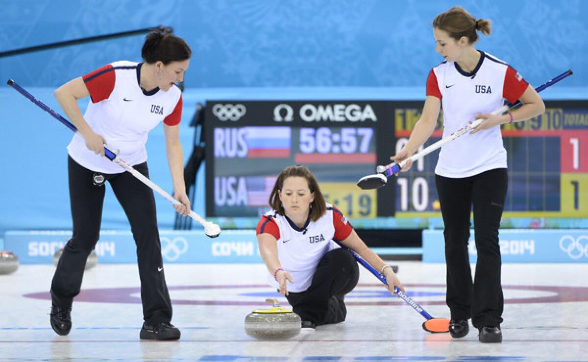 Debbie McCormick, center, throws between American teammates Ann Swisshelm, left, and Jessica Shultz during Tuesday's match against Russia at the Sochi Winter Olympic Games.