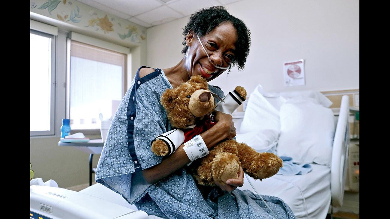 Oncology patient Sherri Stanley of Glendale holds her teddy bear given to her by staff at Adventist Health Glendale during the annual Hug A Bear event, at the hospital in Glendale on Thursday, Dec. 21, 2017. Sixty bears were passed out to patients, 30 donated by an anonymous donor and 30 by Bloomingdales. Ten of the bears were given to children in the hospital's Play to Learn Center.