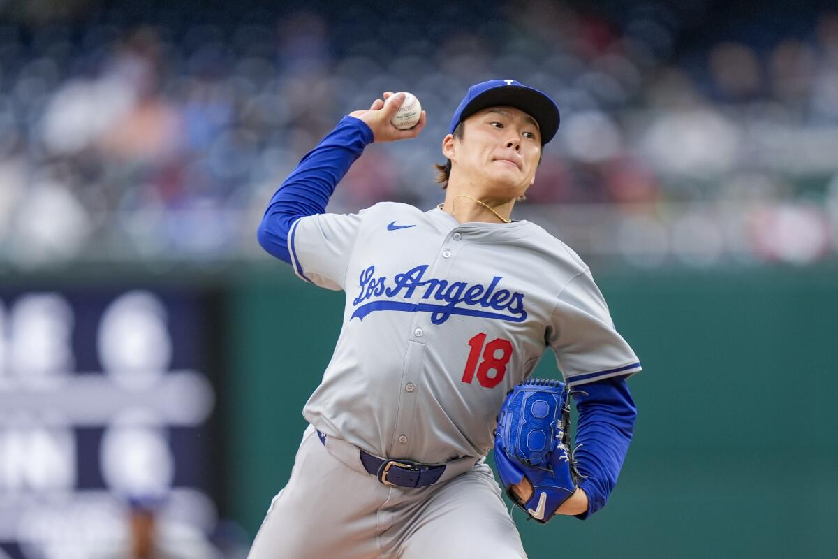 Dodgers pitcher Yoshinobu Yamamoto throws a pitch