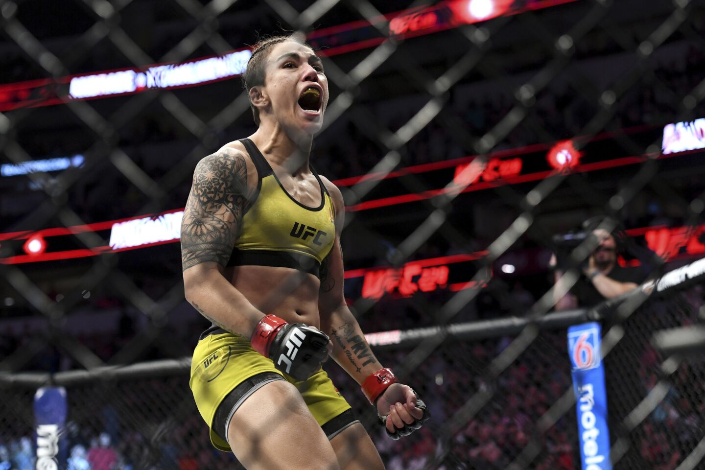 Jessica Andrade celebrates after knocking out Karolina Kowalkiewicz during their strawweight title mixed martial arts bout at UFC 228 on Saturday, Sept. 8, 2018, in Dallas. (AP Photo/Jeffrey McWhorter)