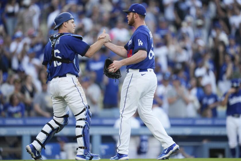 Dodgers catcher Will Smith and reliever Caleb Ferguson celebrate the team's 4-2 home win over San Diego on May 13, 2023.
