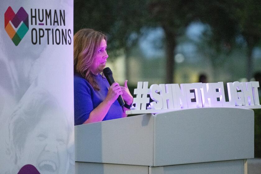 Human Options CEO Maricela Rios-Faust speaks at the Shine the Light walking vigil at Lions Park.