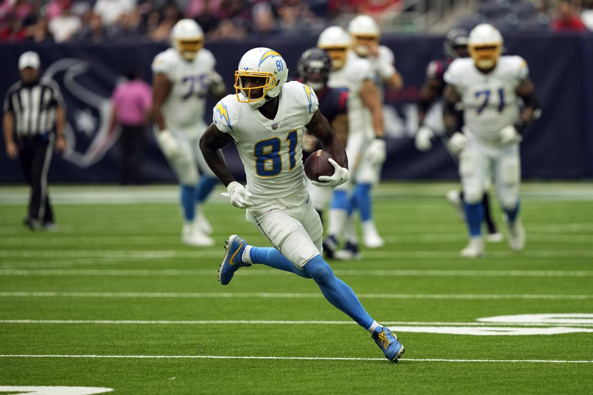 Chargers wide receiver Mike Williams runs with the ball after making a catch against the Houston Texans last week.