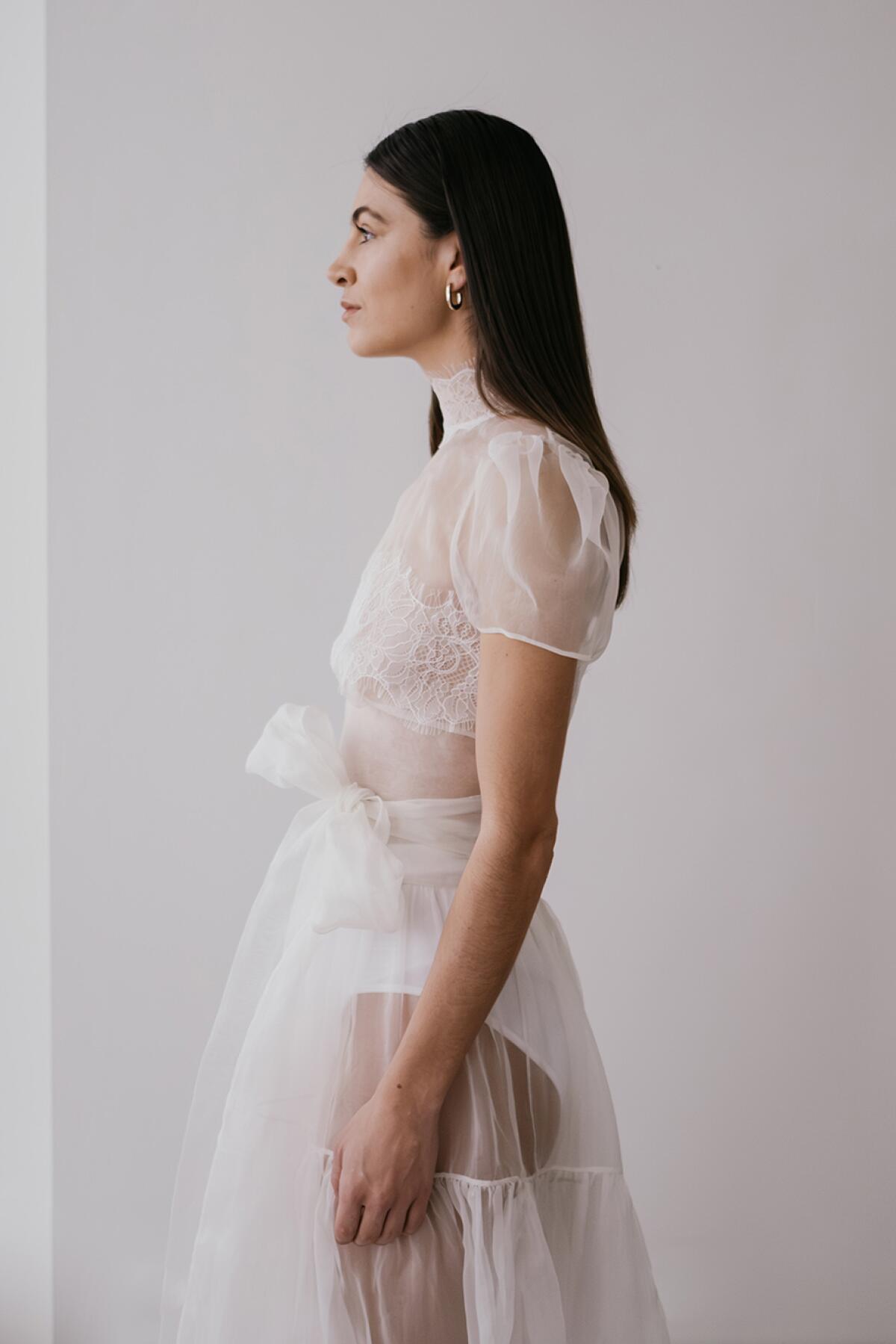 A model wears a wedding dress by UNBRIDLED.