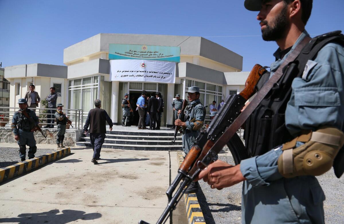 Afghan police secure the venue where presidential candidates are registering on the last day of sign-ups in Kabul, Afghanistan, on Sunday.