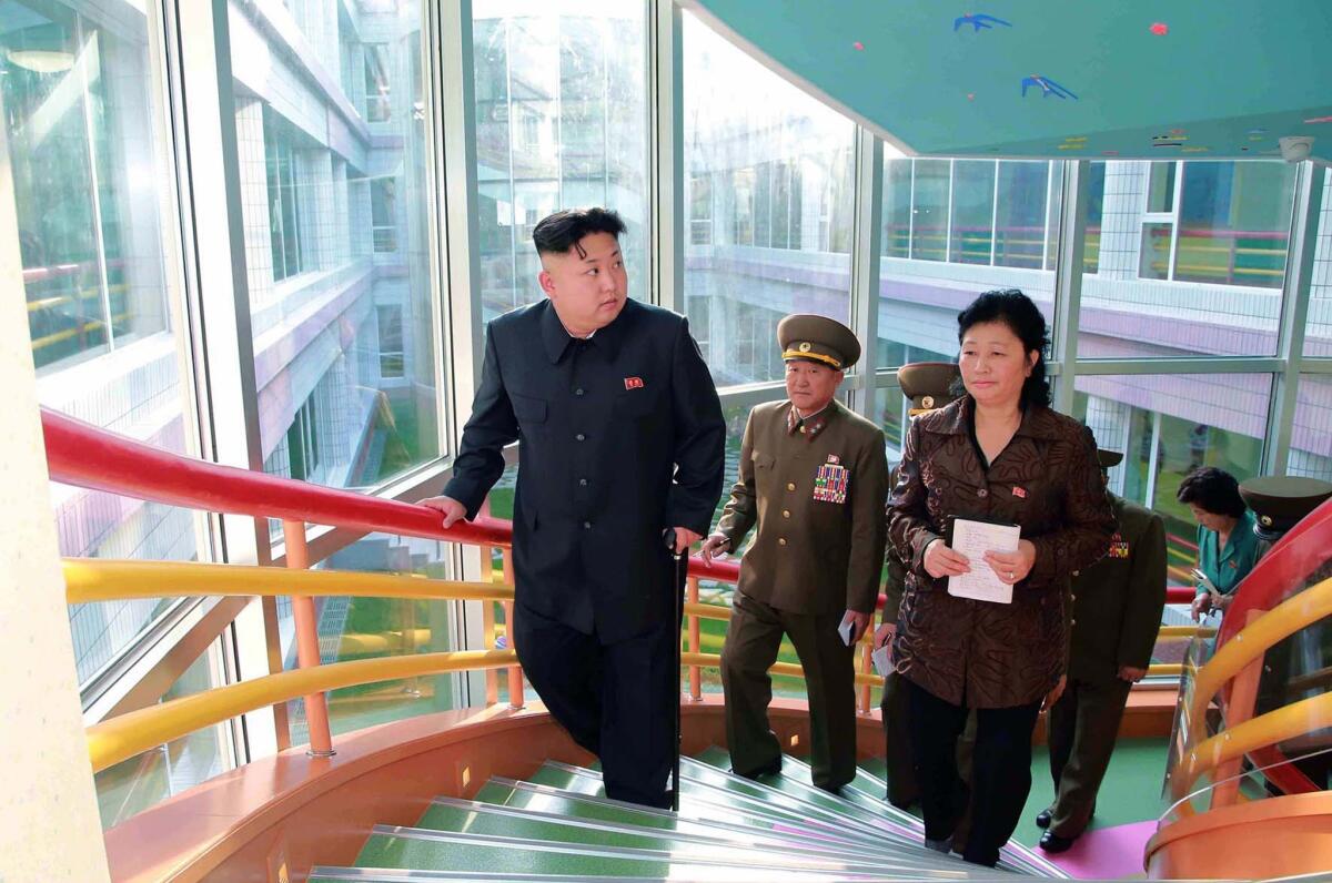This undated picture released from North Korea's official Korean Central News Agency on Oct. 26 shows North Korean leader Kim Jong Un, left, visiting a home for infants and orphans in Pyongyang.