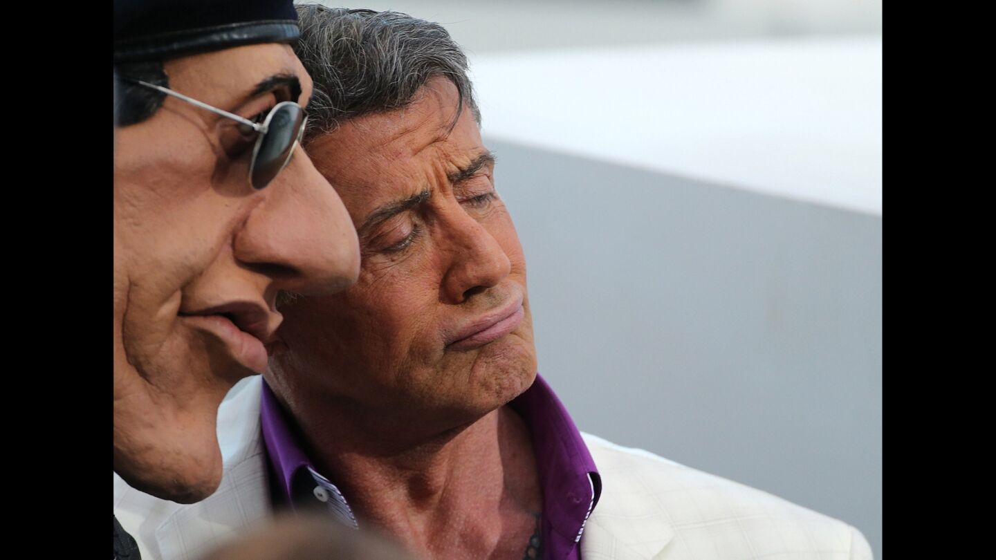 Sylvester Stallone poses with his puppet as he takes part in the TV show "Le Grand Journal" at the Cannes Film Festival.
