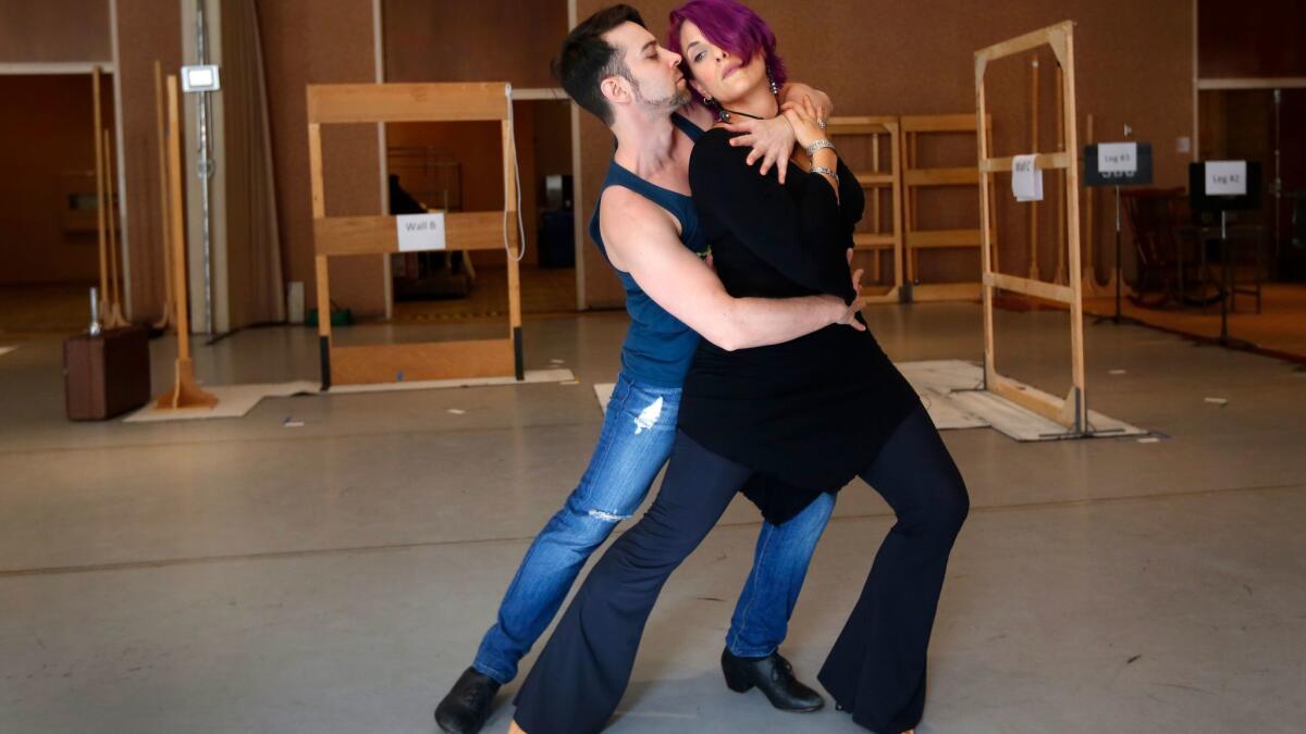 Stage director John de los Santos rehearses some dance moves with mezzo-soprano Audrey Babcock who plays the title role in San Diego Opera's tango opera "Maria de Buenos Aires," which will be performed at the Lyceum Theatre Jan. 26-28.