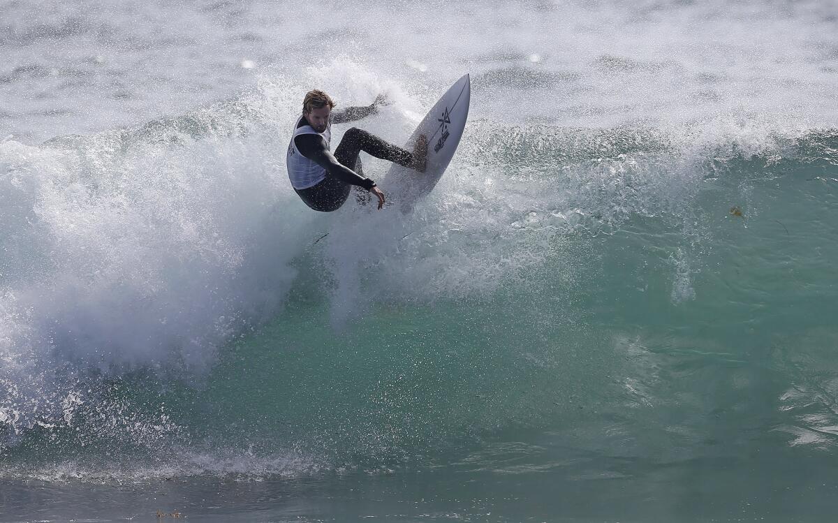 Eli Viszolay of Laguna Beach goes off the top of a big wave en route to winning the masters division final Sunday.