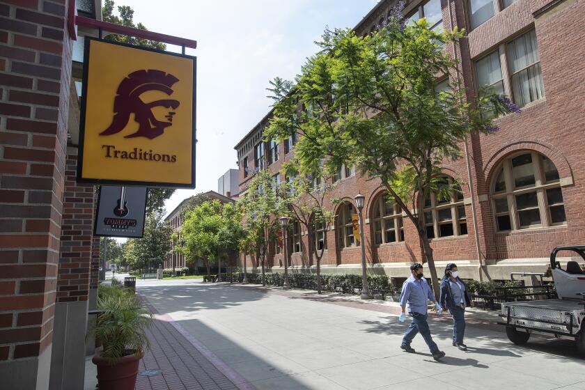LOS ANGELES, CA - JULY 02, 2020: Custodians make their way on the campus of USC in Los Angeles. A month after announcing a return to an in-person fall semester, the University of Southern California has reverted to mostly online classes. Los Angeles, CA. (Mel Melcon / Los Angeles Times)