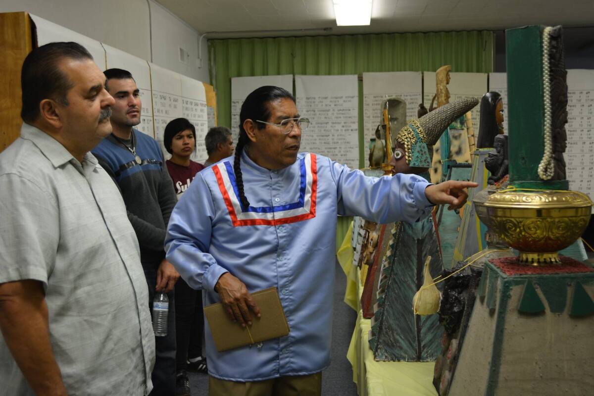 David Vazquez, center, hosted a Nahuatl exhibition in 2017 at the Episcopal Church of the Messiah in Santa Ana.