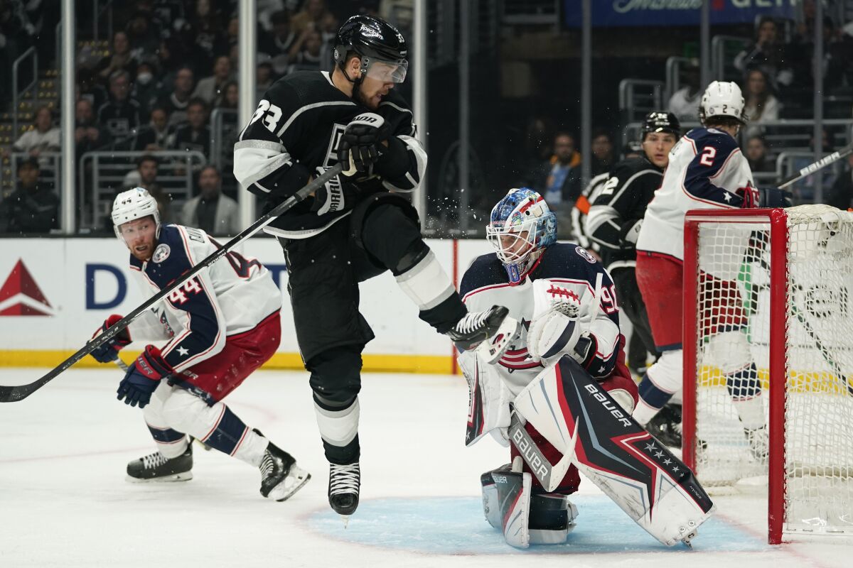 Los Angeles Kings left wing Viktor Arvidsson (33) jumps near Columbus Blue Jackets goaltender Elvis Merzlikins (90)during the second period of an NHL hockey game Saturday, April 16, 2022, in Los Angeles. (AP Photo/Ashley Landis)