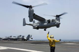 FILE -In this image provided by the U.S. Navy, Aviation Boatswain's Mate 2nd Class Nicholas Hawkins, signals an MV-22 Osprey to land on the flight deck of the USS Abraham Lincoln in the Arabian Sea on May 17, 2019. The military has greenlighted its Osprey to return to flight, three months after a part failure led to the deaths of eight service members in a crash in Japan in November. Naval Air Systems Command announced it on Friday. (Mass Communication Specialist 3rd Class Amber Smalley/U.S. Navy via AP, File)