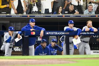 San Diego, CA - October 15: The Los Angeles Dodgers dugout watches after losing the lead during the seventh inning in game 4 of the NLDS against the San Diego Padres at Petco Park on Saturday, Oct. 15, 2022 in San Diego, CA. (Wally Skalij / Los Angeles Times)