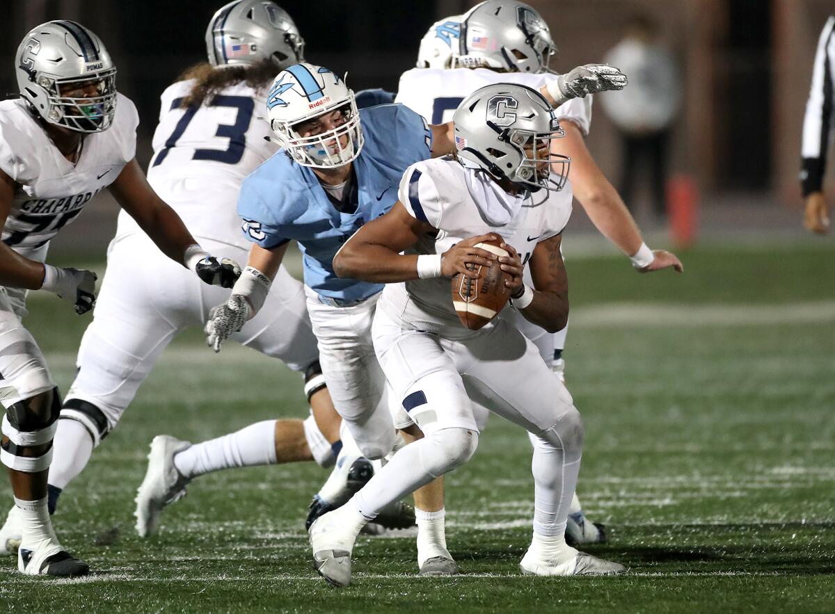 Corona del Mar's Ryan Nielsen (45) closes in on Chaparral quarterback Caron Tyler for a sack.