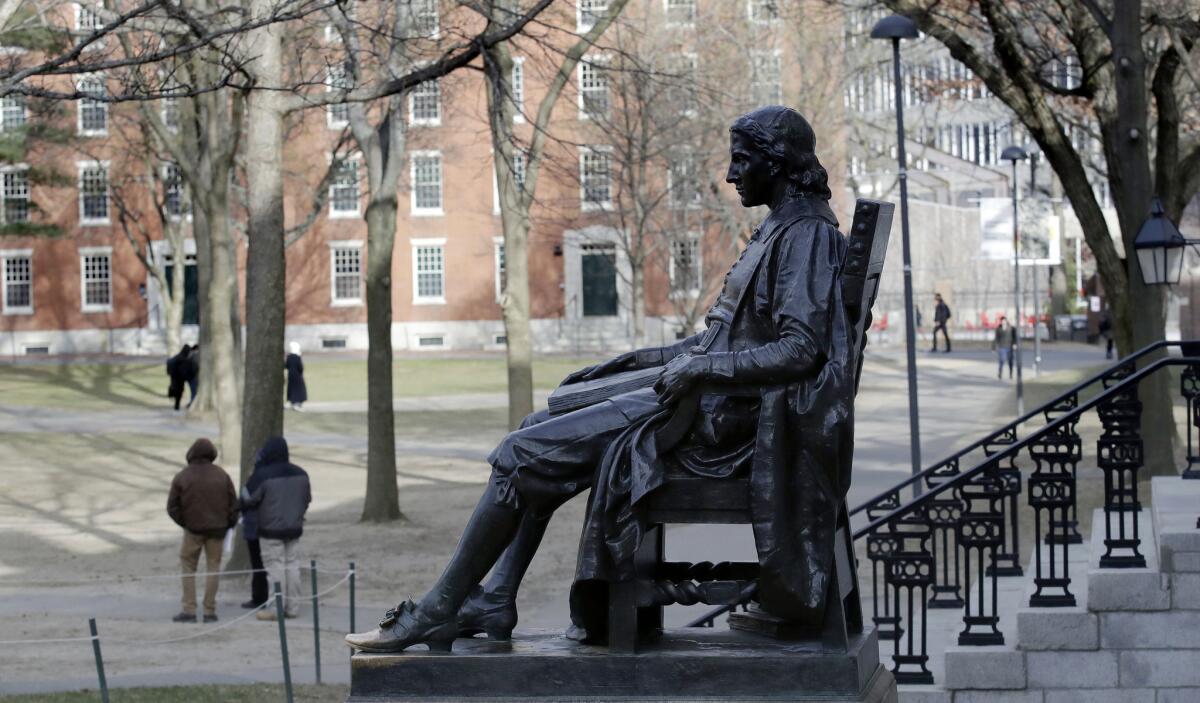 John Harvard statue looks over Harvard Yard in Cambridge, Mass.