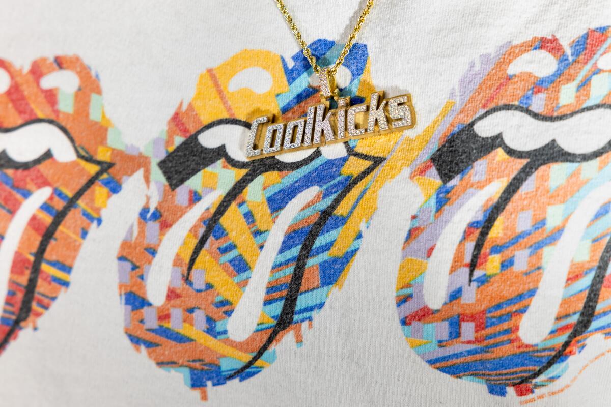 A pendant with the CoolKicks logo.