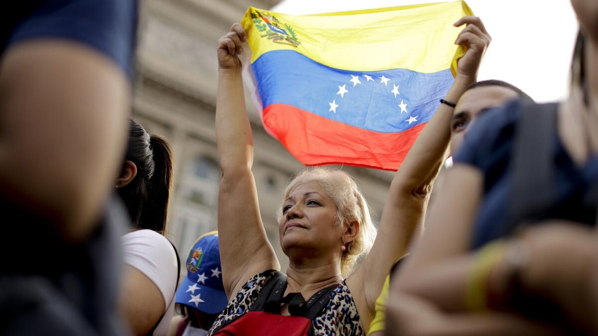 A Venezuelan anti-government protester holds a Venezuelan flag during a demonstration in Buenos Aires on Jan. 23, 2019.