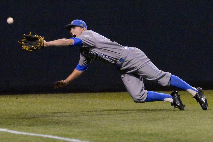 Bruins outfielder Brett Stephens is unable to reach a triple hit by Maryland's Tim Lewis in the second inning Saturday at the UCLA Regional of the the NCAA college baseball tournament.