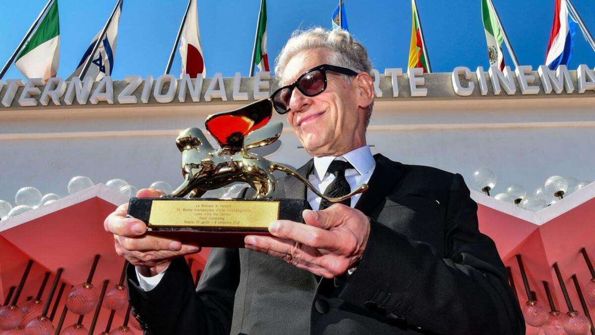 David Cronenberg poses outside the festival's palace after he received a Golden Lion for lifetime achievement award at the 75th Venice Film Festival.