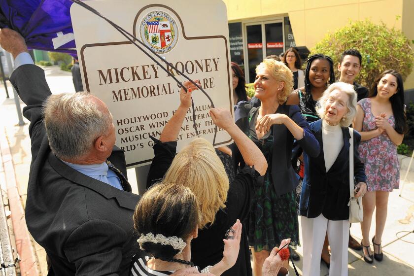 L.A. City Councilman Tom LaBonge helps reveal Mickey Rooney Memorial Square at the intersection of Sunset Boulevard and Orange Drive in Hollywood surrounded by the late actor's family and friends.