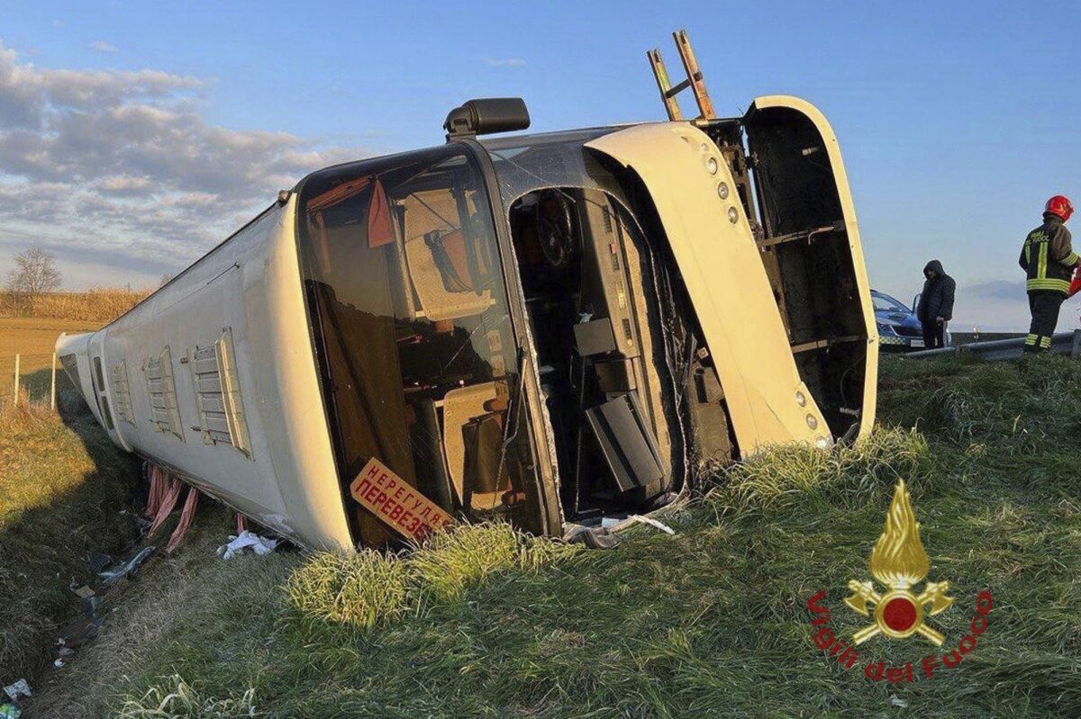 A bus lies on its side after overturning near Forli, Italy, Sunday, March 13, 2022. Italian state radio says that a bus carrying about 50 refugees from Ukraine has overturned on a major highway in northern Italy, killing a passenger and injuring several others, none of them seriously. RAI radio said one woman died and that the rest of those aboard the bus were safely evacuated after the accident early Sunday near the town of Forli’. (Vigili del Fuoco via AP)
