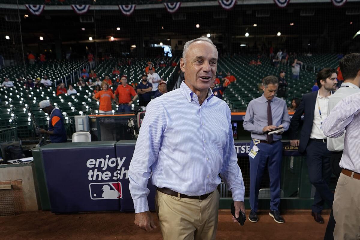 MLB commissioner Rob Manfred walks on the field before Game 2 of the ALDS in Houston on Oct. 13, 2022.